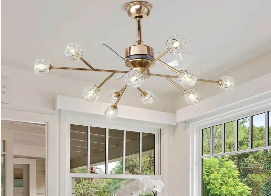 A gold crystal chandelier fan above a bright dining nook